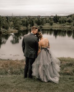 _DSC7520 couple looking out at a lake in wedding photo
