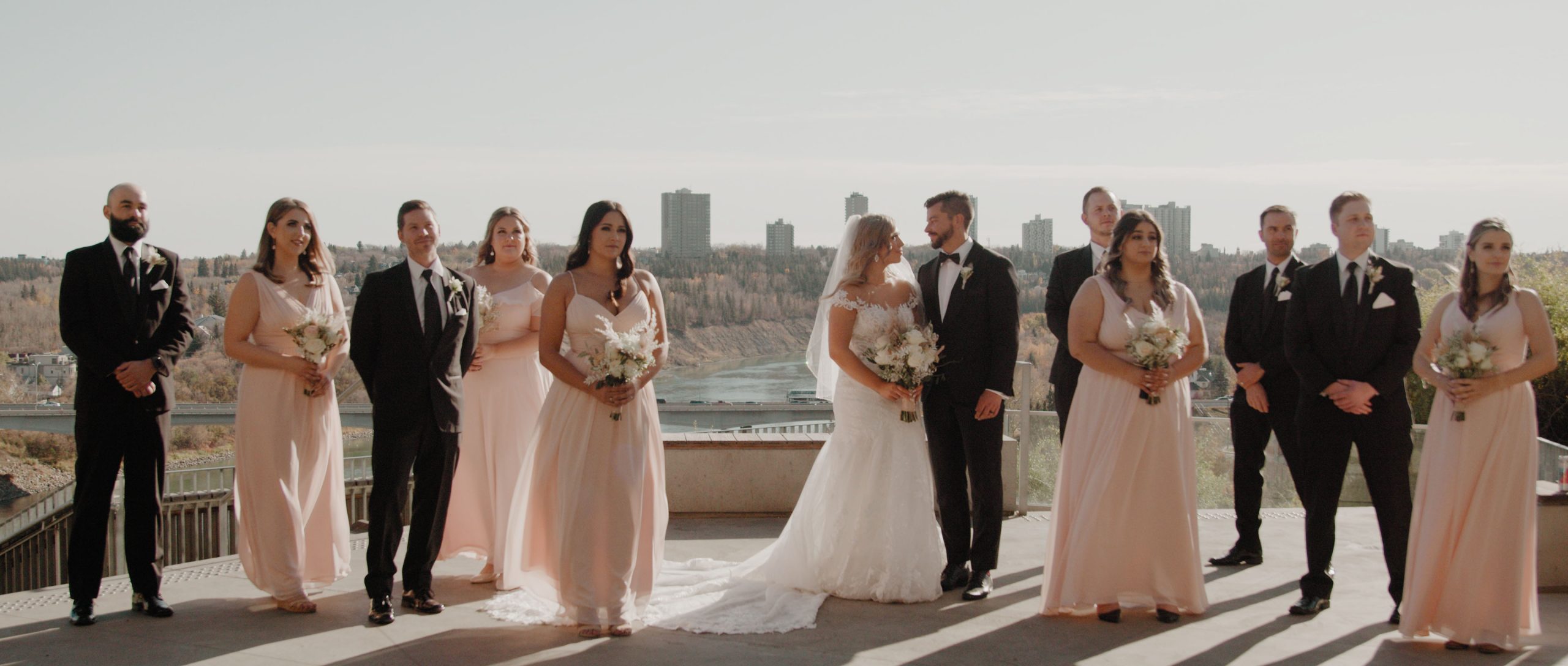 Bridal Party posing in front of river valley in the fall